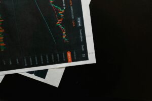 Financial charts showing upward trending stock market data on computer screens