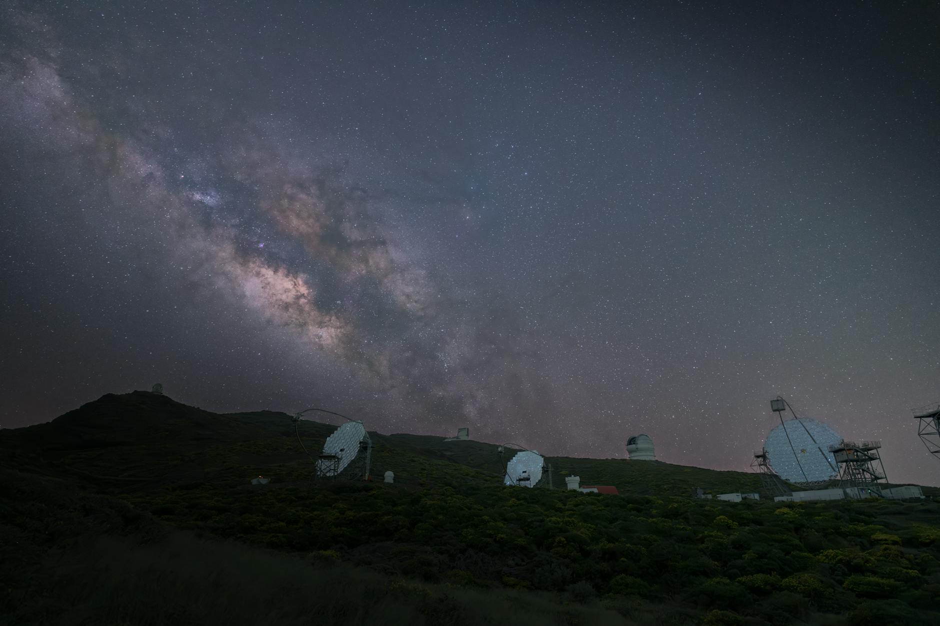 Large telescope in observatory dome pointing toward night sky