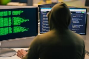 Computer screens displaying cybersecurity threat monitoring systems