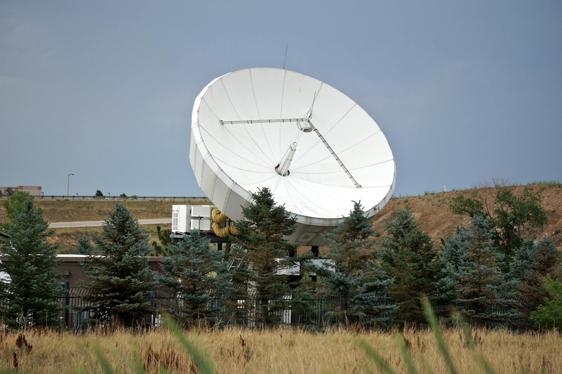 Large satellite communication dish against blue sky