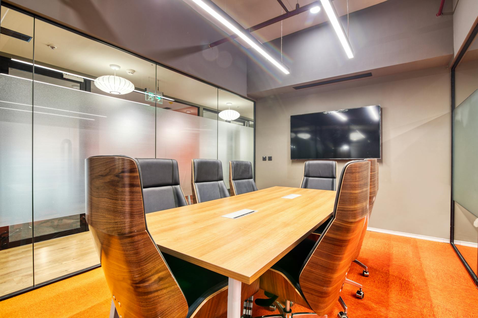Modern corporate boardroom with executives discussing financial strategy around conference table