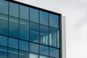 Modern commercial office building with glass facade representing middle market real estate investments