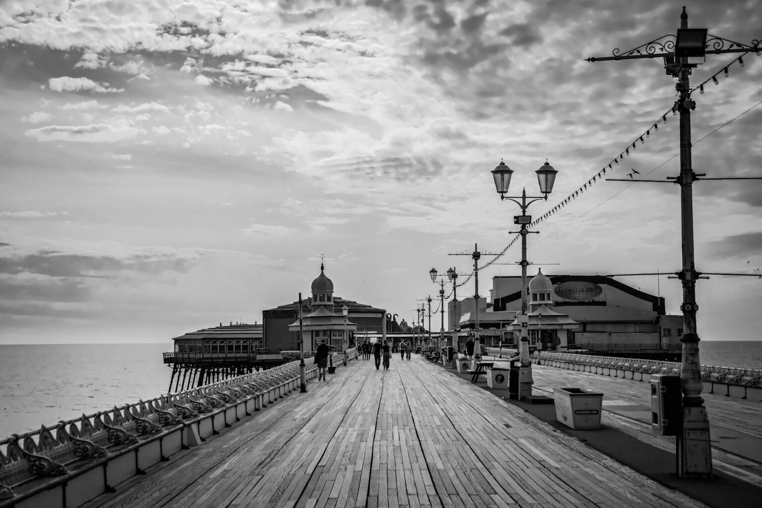 Tourists gathering at waterfront pier taking photos