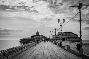 Tourists gathering at waterfront pier taking photos