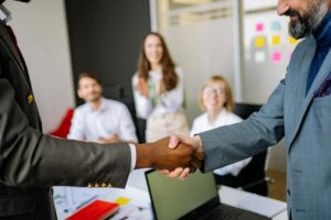 Business professionals shaking hands during trade negotiations