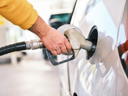Gas station price display showing rising fuel costs