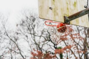 Basketball game displayed on television screen showing playoff action