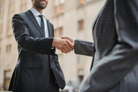 Business leaders shaking hands in formal diplomatic setting