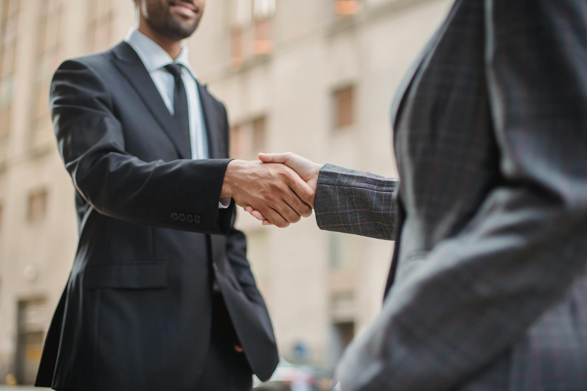 Business leaders shaking hands in formal diplomatic setting