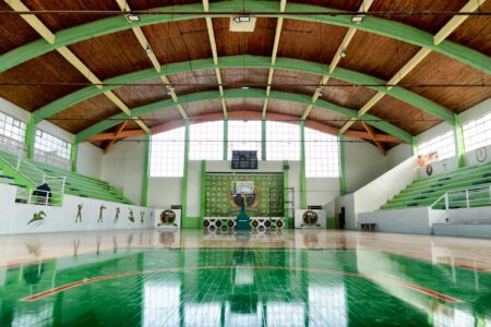 Empty basketball arena with bright court lighting