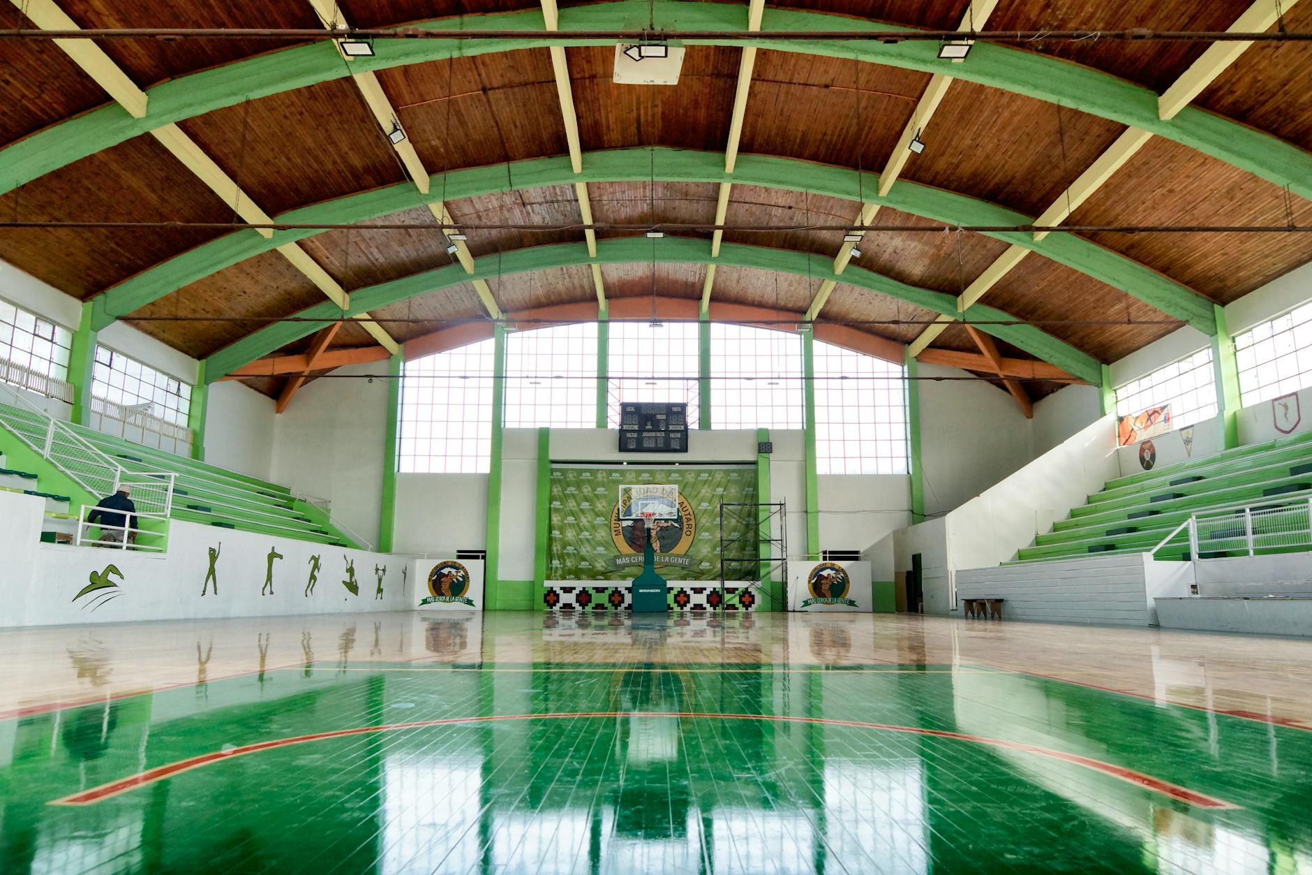 Empty basketball arena with bright court lighting