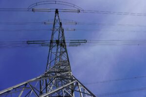 High voltage transmission lines against blue sky