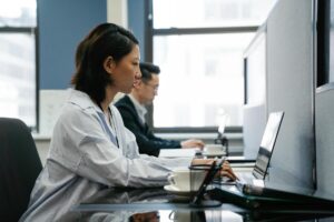 Office workers at desks using computers in a modern workplace