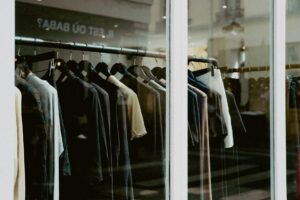 Interior of a clothing retail store with apparel displayed on racks