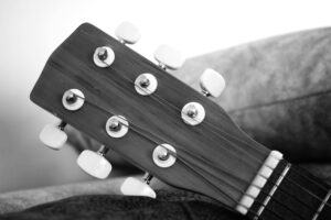 Close-up of acoustic guitar strings and fretboard in soft light