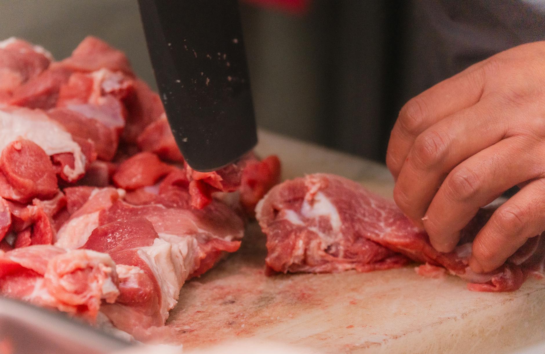 Industrial meat processing facility with workers and equipment
