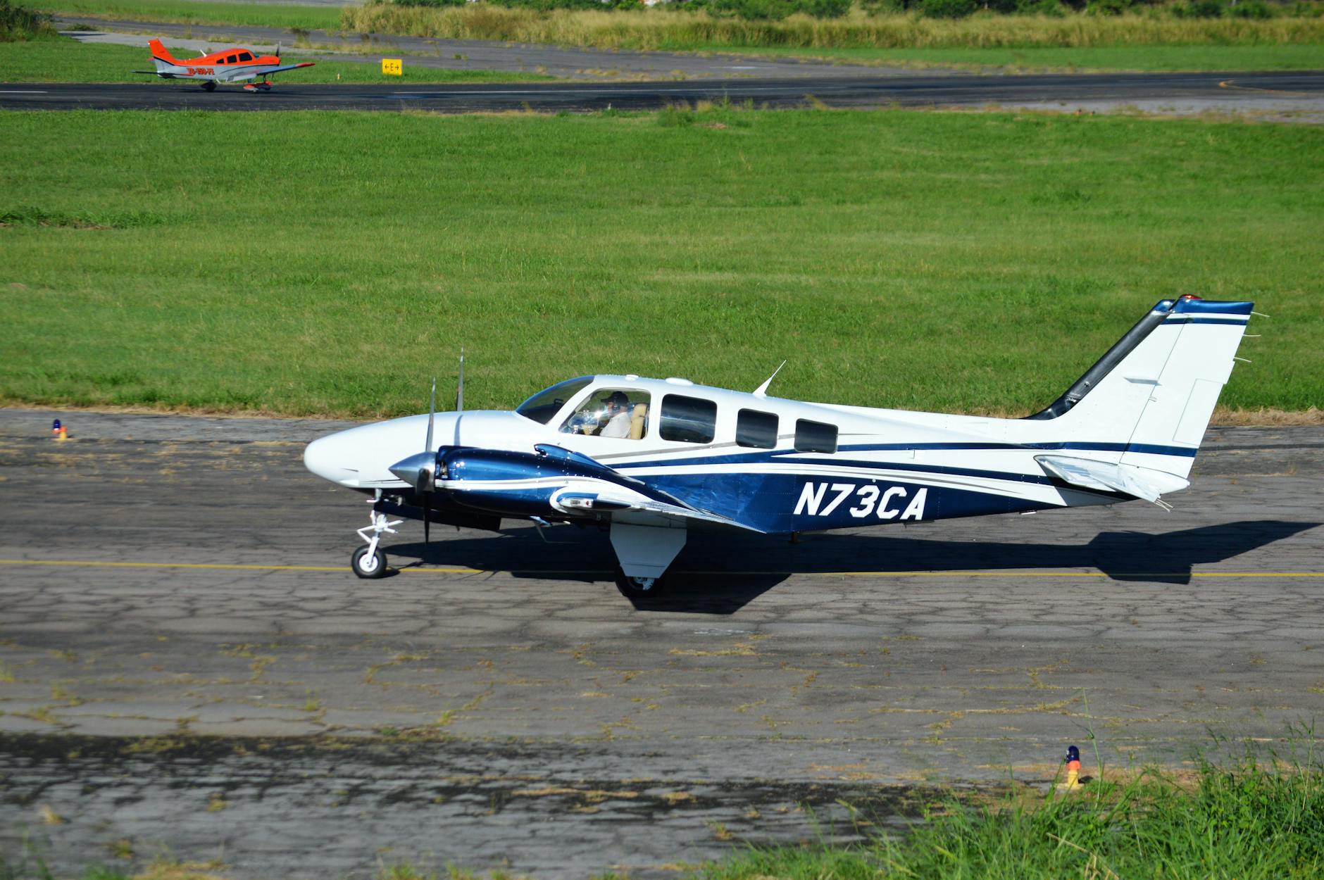 Small plane flying with advertising banner against blue sky