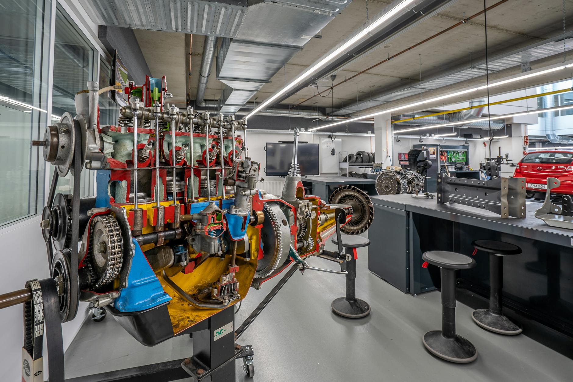 Engineers working on an electric vehicle chassis in a modern facility