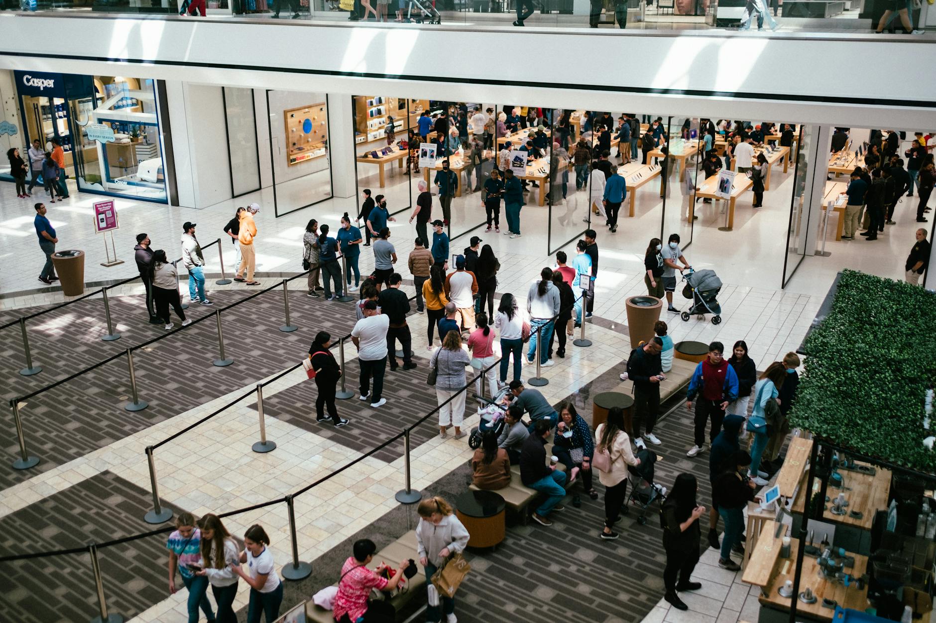 Shoppers walking through a retail mall, browsing store windows