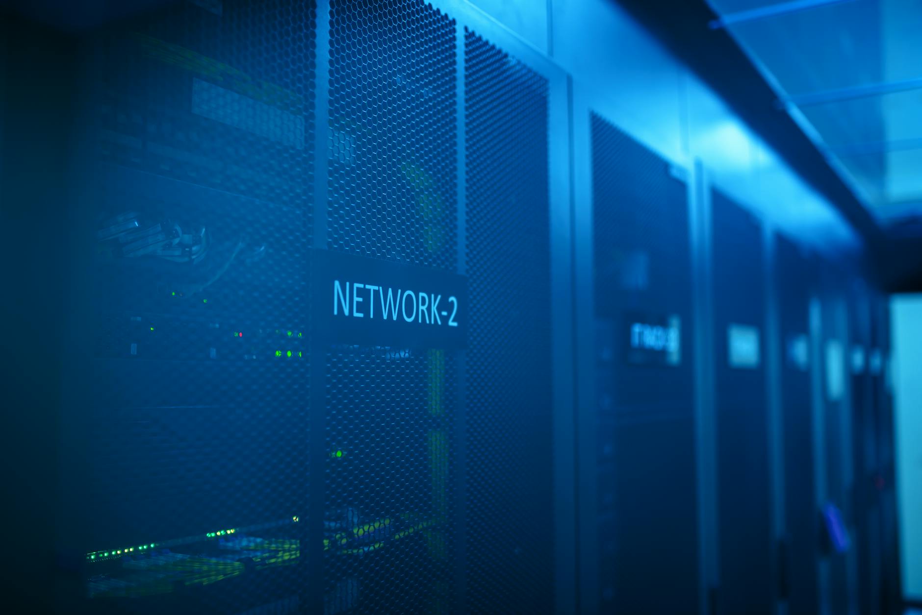 Data center server room with blue lighting and network equipment racks