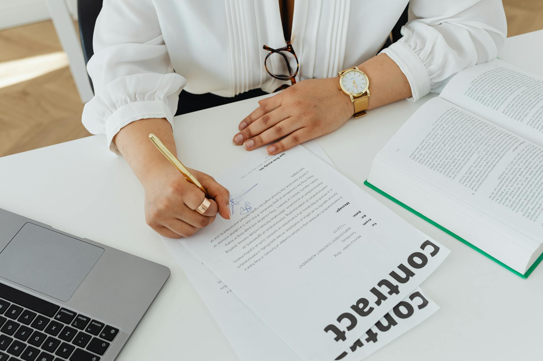 Business professionals reviewing and signing commercial contracts