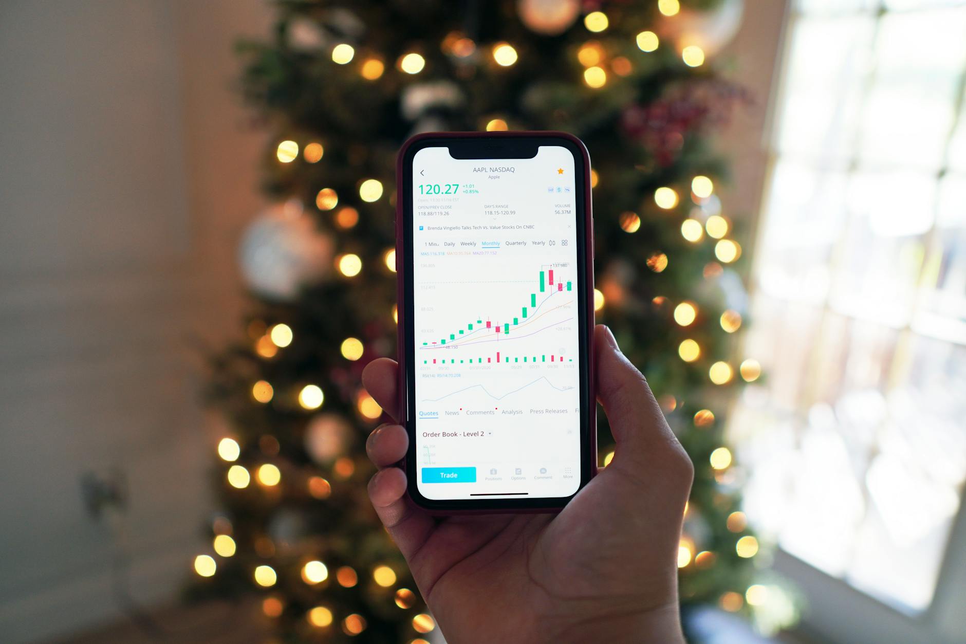 Mobile phone displaying financial trading application interface
