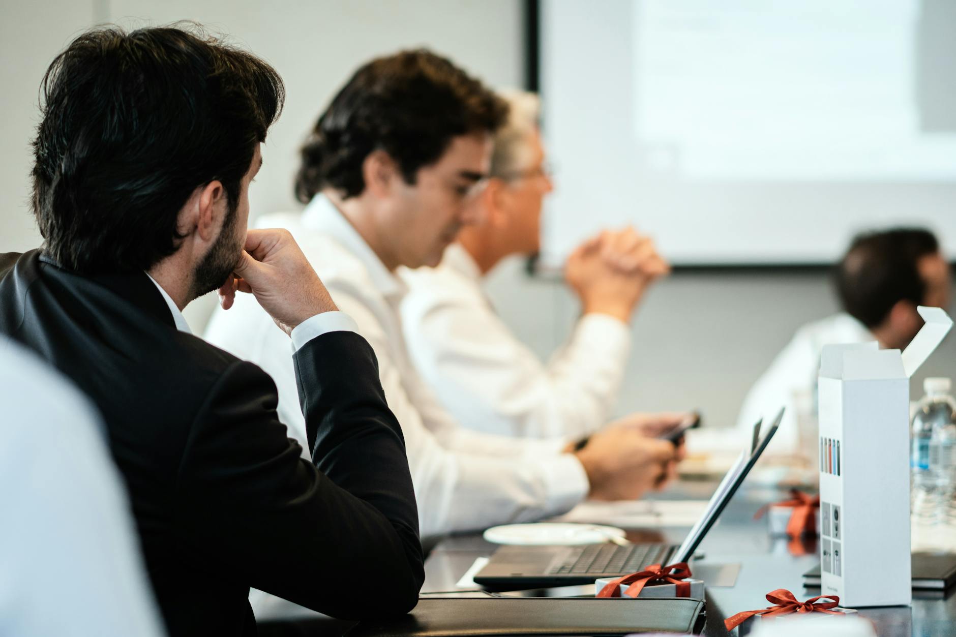 Business executives in discussion around a boardroom table