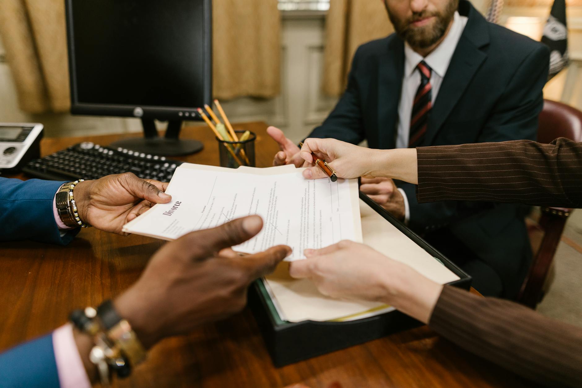 Two officials reviewing documents across a table in a formal office setting