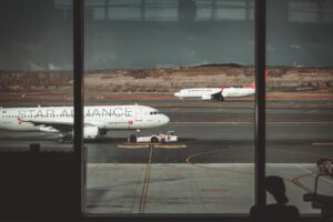 Passengers walking through a busy international airport terminal
