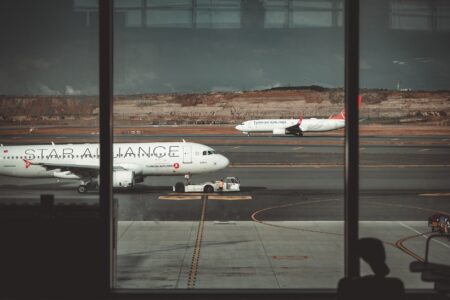 Passengers walking through a busy international airport terminal
