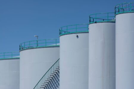 Large commercial crude oil storage tanks at an industrial facility