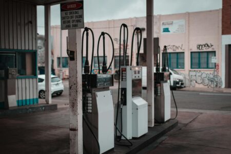 Iran War Fuel Costs Push American Shoppers to Rethink Every Purchase Driver pumping gas at a fuel station as prices rise
