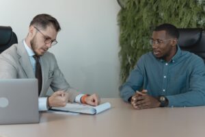 U.S. Job Openings Hit 7.6 Million, a Two-Year High With Strings Attached Two people shaking hands across a desk during a job interview