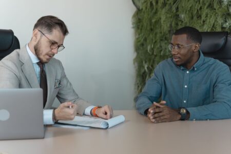 U.S. Job Openings Hit 7.6 Million, a Two-Year High With Strings Attached Two people shaking hands across a desk during a job interview
