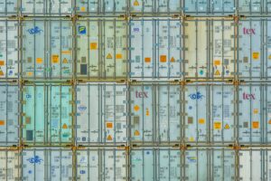 Large cargo shipping containers at an international port representing global trade