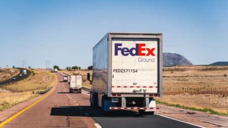 FedEx delivery truck on a highway representing the company's core parcel business