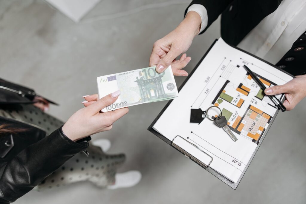 Person signing real estate documents at a closing table