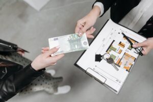 Person signing real estate documents at a closing table