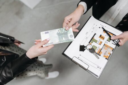 Person signing real estate documents at a closing table