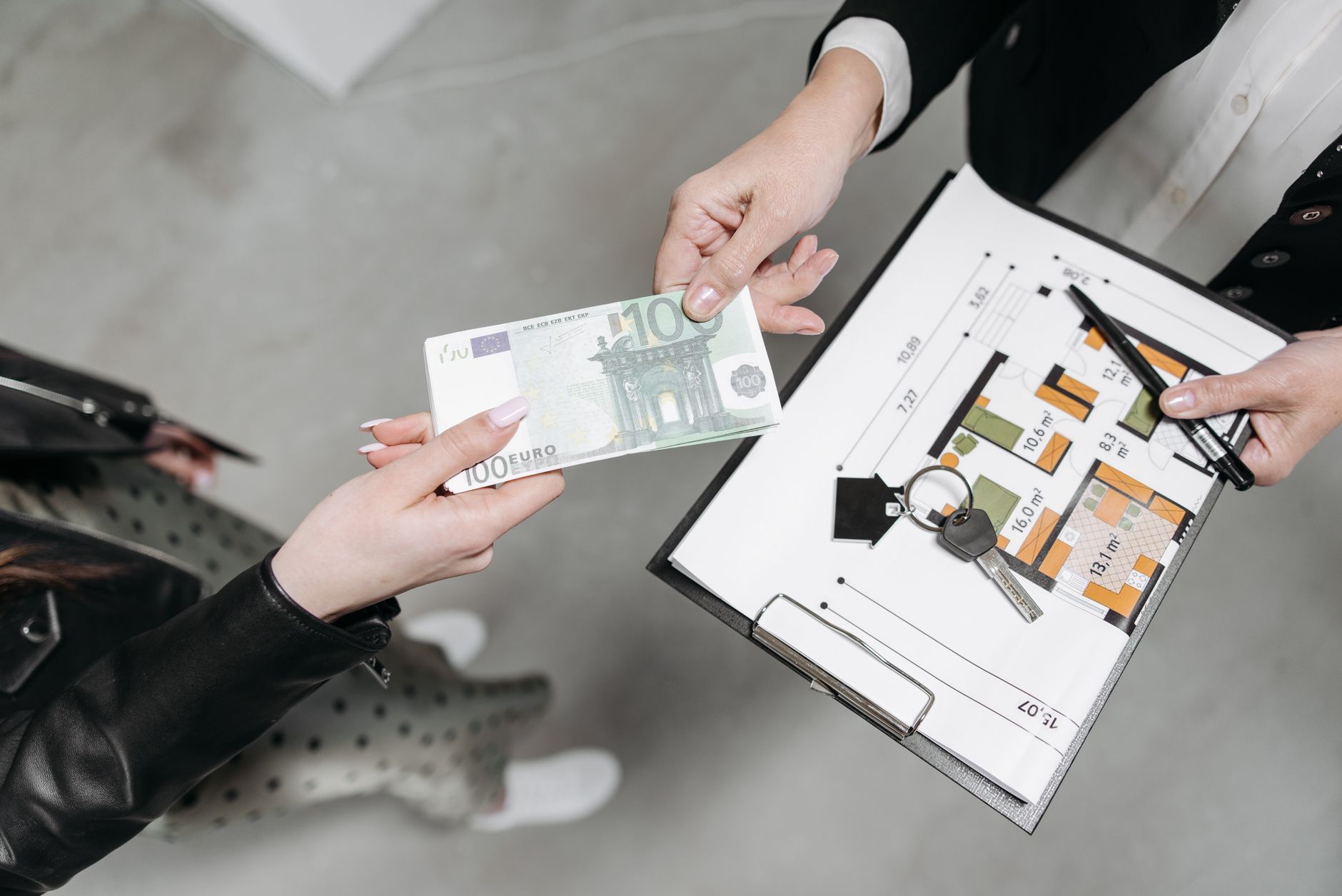 Person signing real estate documents at a closing table