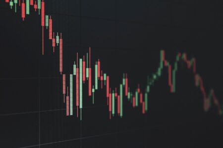 Stock market board showing declining tech sector prices during a volatile trading week