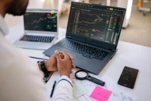 Stock market trading screens showing red and declining futures numbers