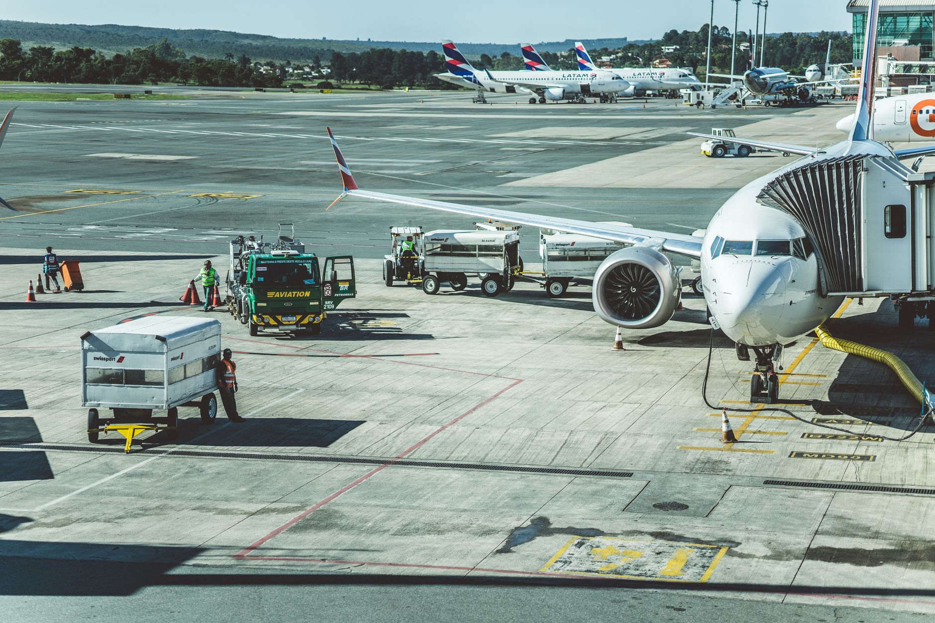 Ground crew refueling a commercial aircraft on the tarmac