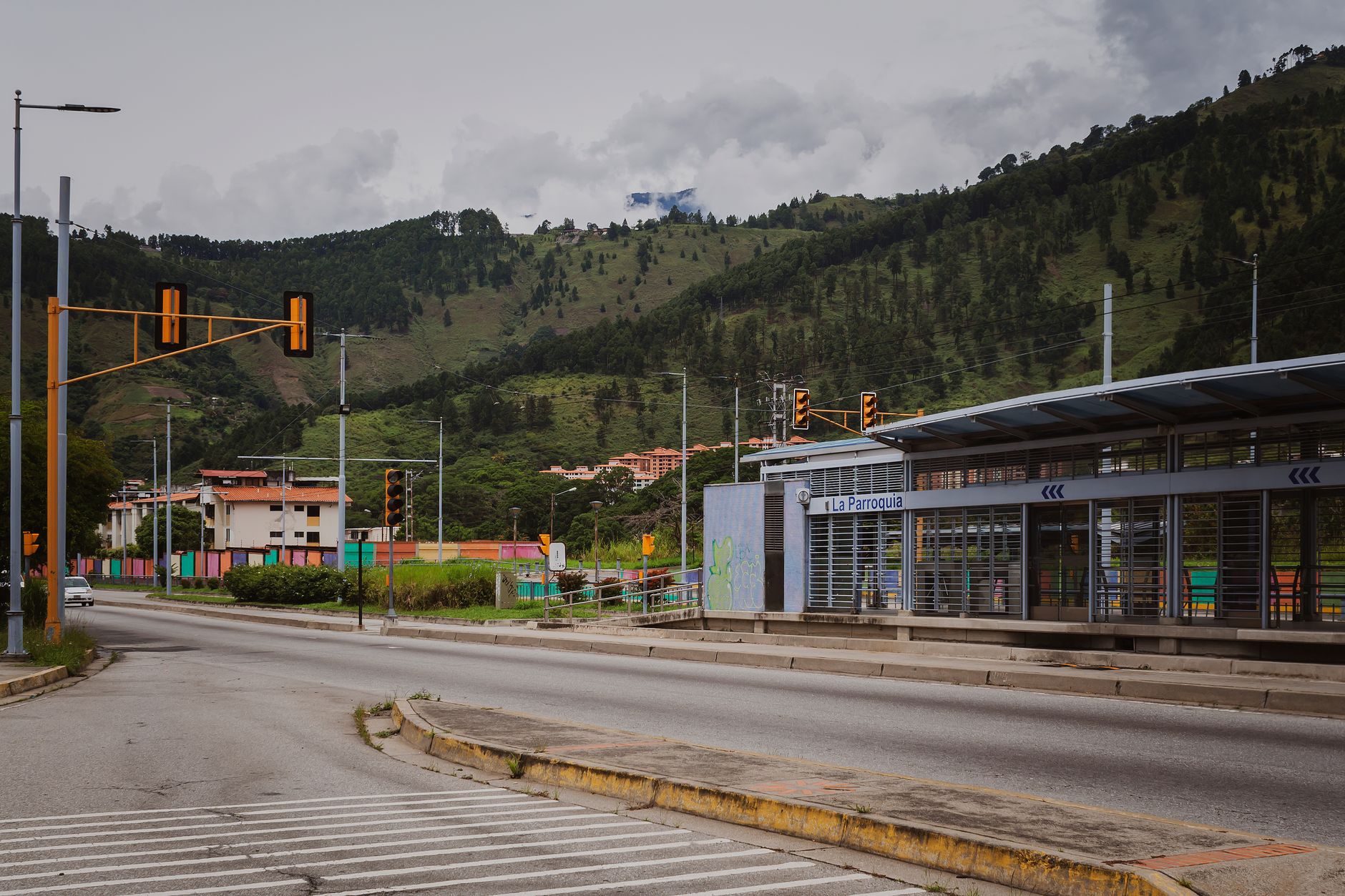 Busy urban street in a Latin American city with pedestrians and storefronts
