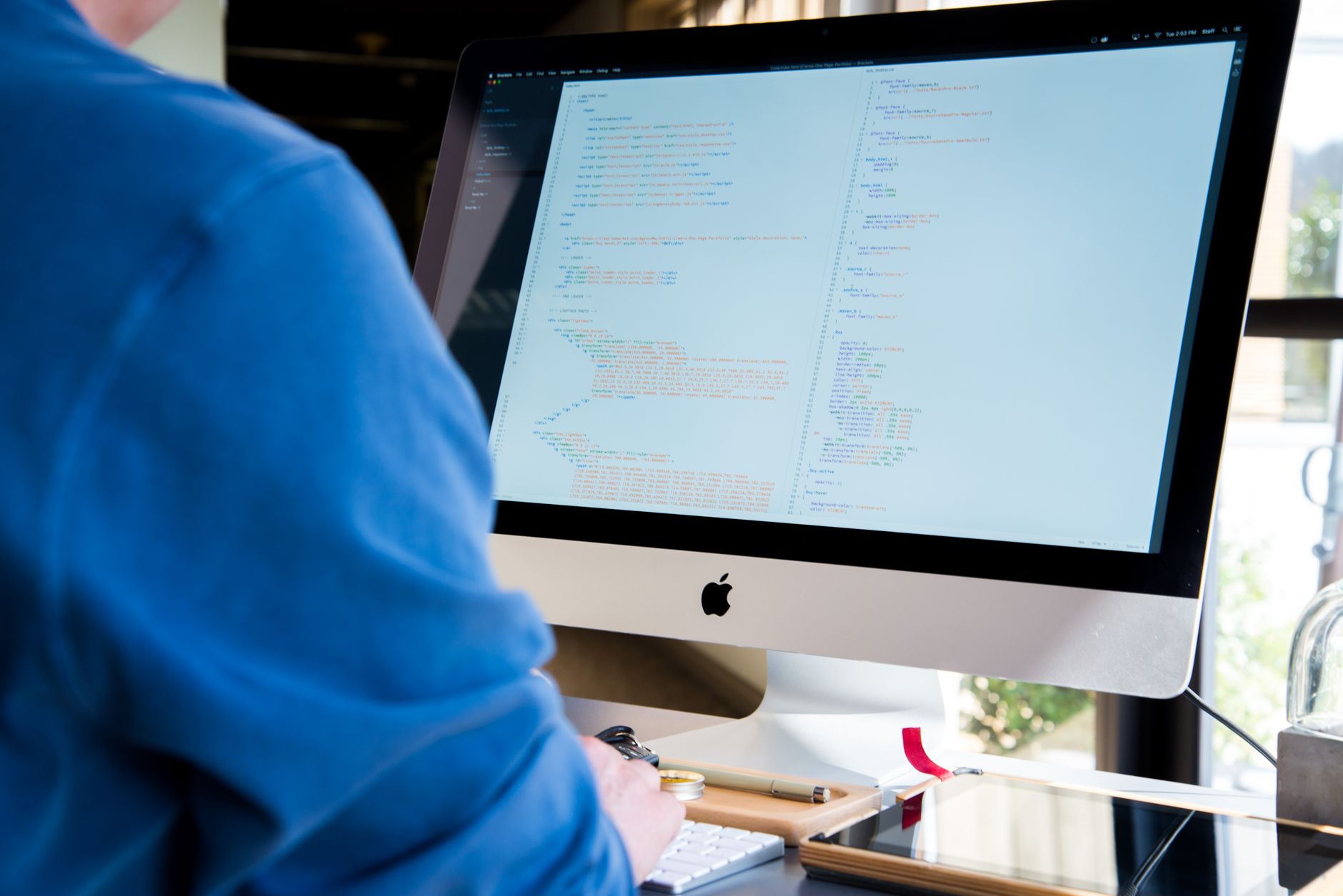 Software developer working at a computer, representing AI-assisted coding tools