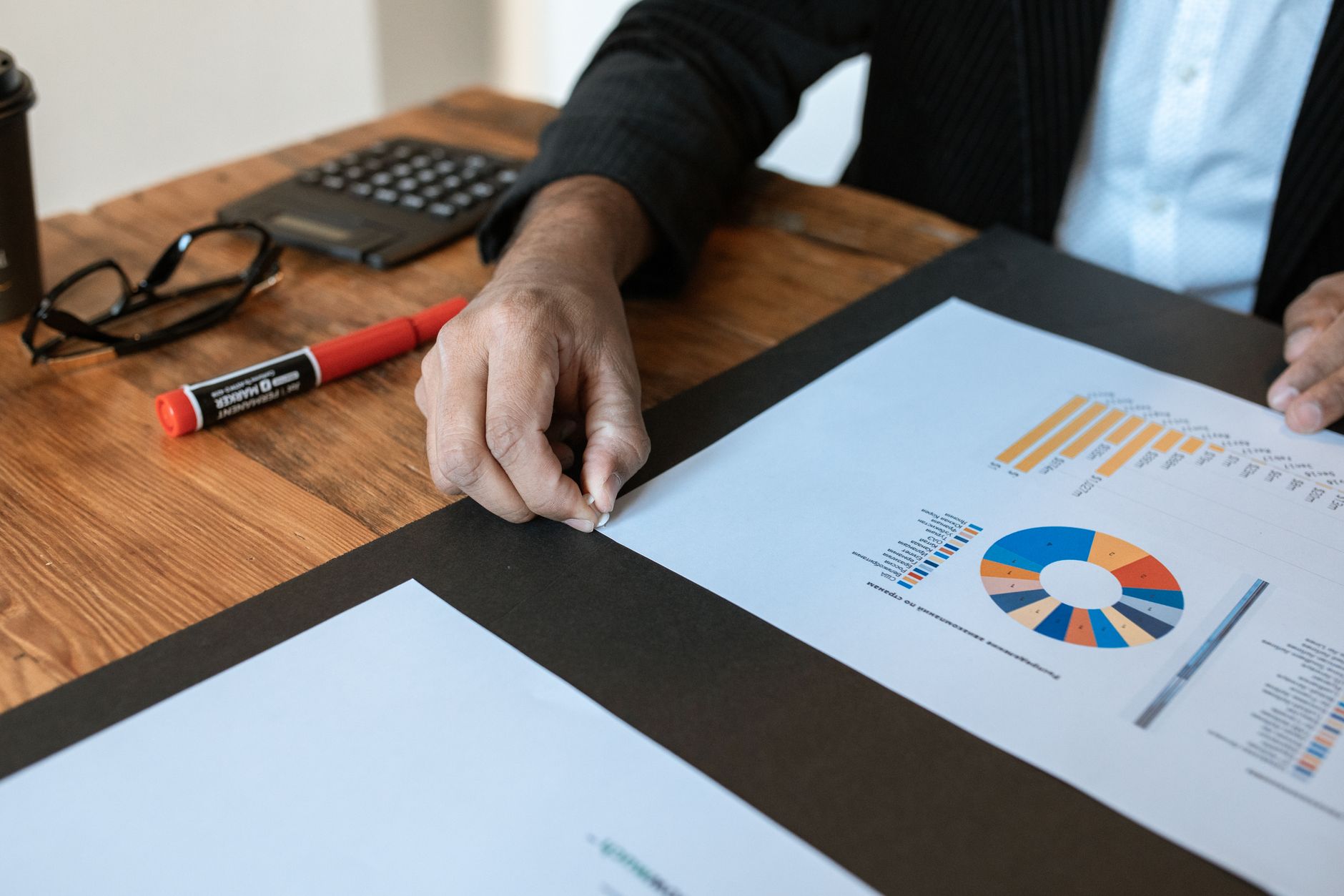 Financial analyst reviewing earnings data on a computer screen with charts visible