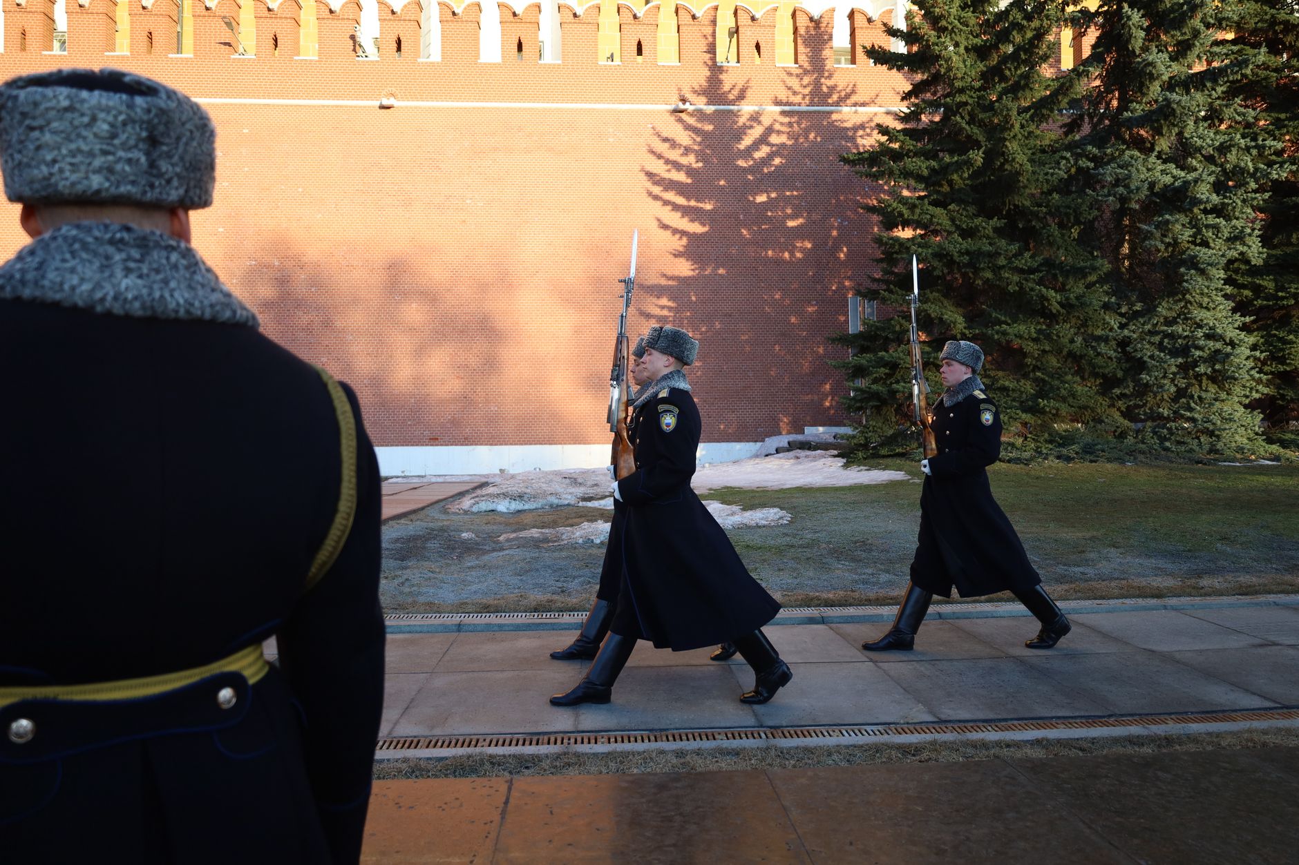 Armed National Guard officers standing at a security perimeter in a city street