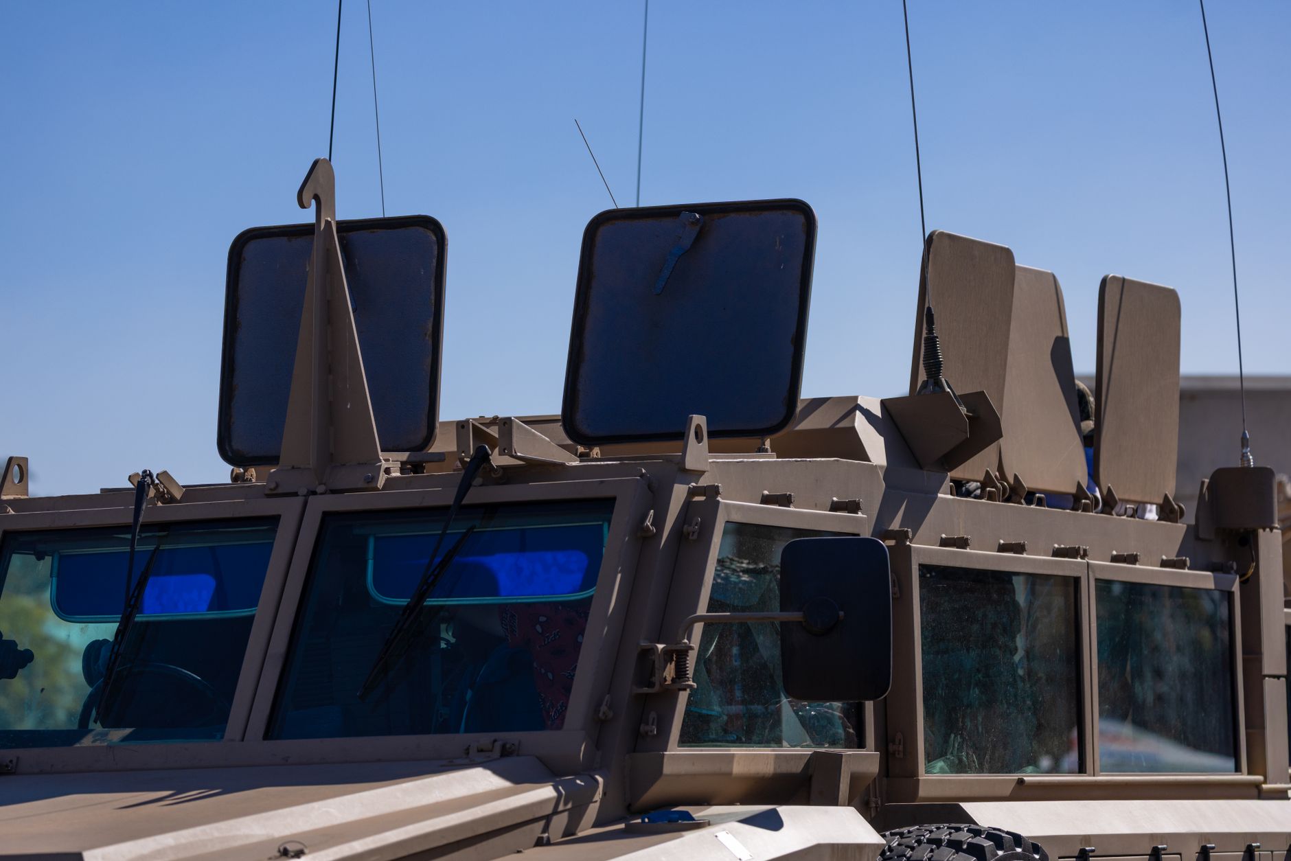 Defense technology control room with screens displaying satellite data
