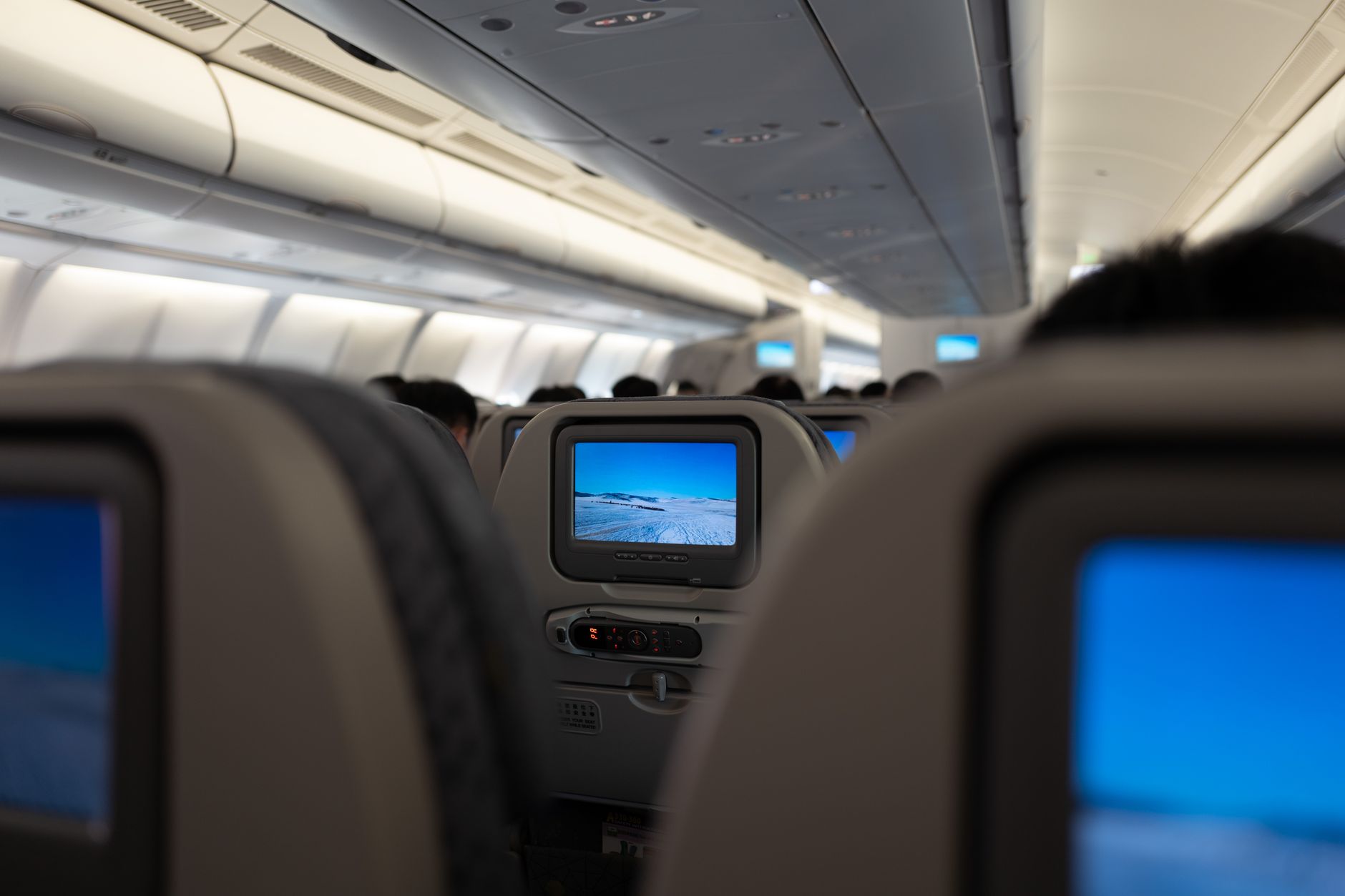 Modern commercial airplane passenger cabin with rows of seats