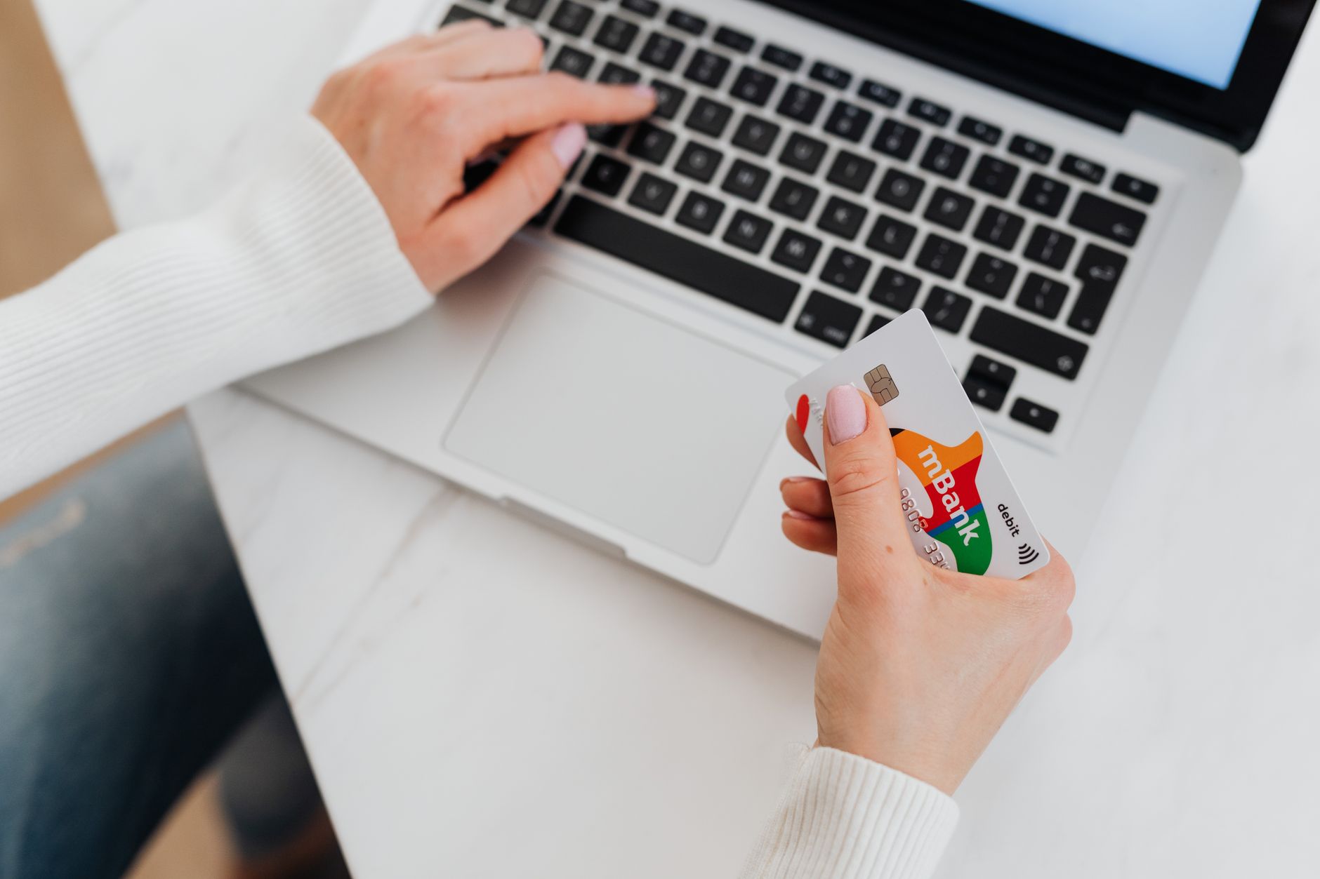 Person using laptop to compare online bank account rates